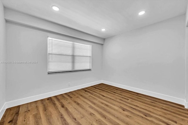 empty room with hardwood / wood-style flooring