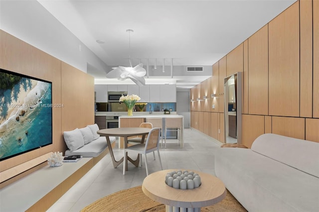 dining room with sink and light tile patterned floors