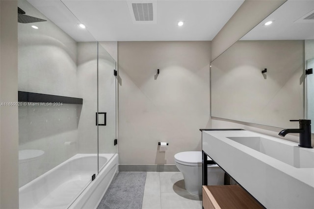 full bathroom with vanity, toilet, bath / shower combo with glass door, and tile patterned floors