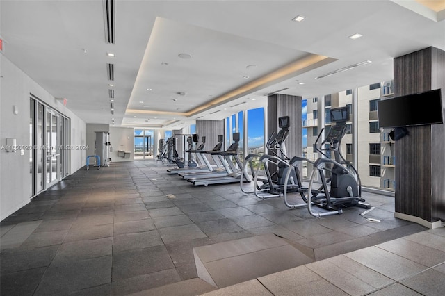 gym with a raised ceiling