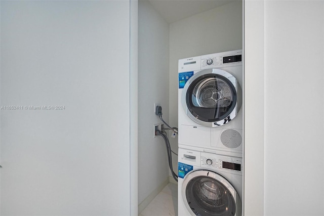 clothes washing area with stacked washer / drying machine