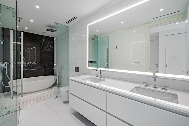 full bathroom featuring tile walls, toilet, shower with separate bathtub, and vanity