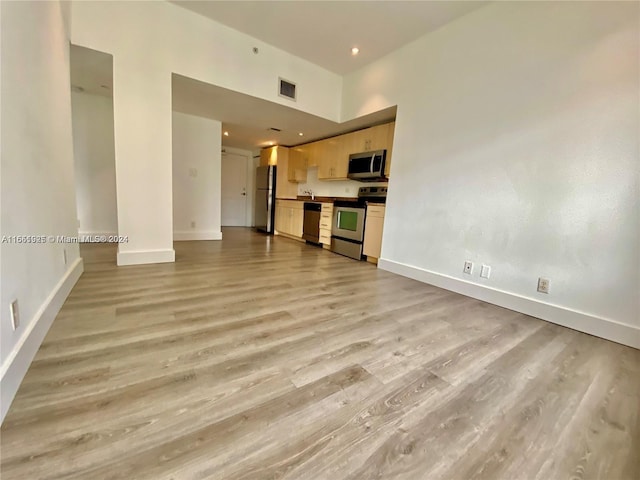 unfurnished living room featuring wood-type flooring