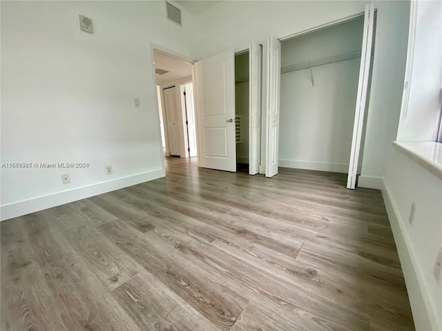 unfurnished bedroom featuring hardwood / wood-style flooring