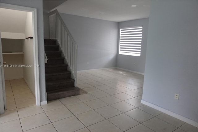 stairway with tile patterned floors