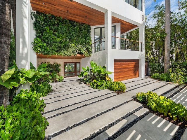 view of patio / terrace with a garage and a balcony