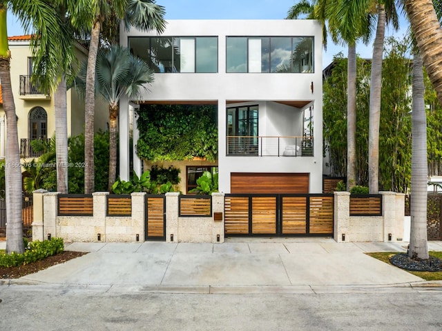 modern home featuring a balcony and a garage