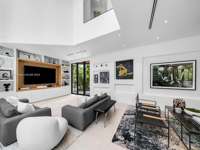 living room featuring built in features and a high ceiling