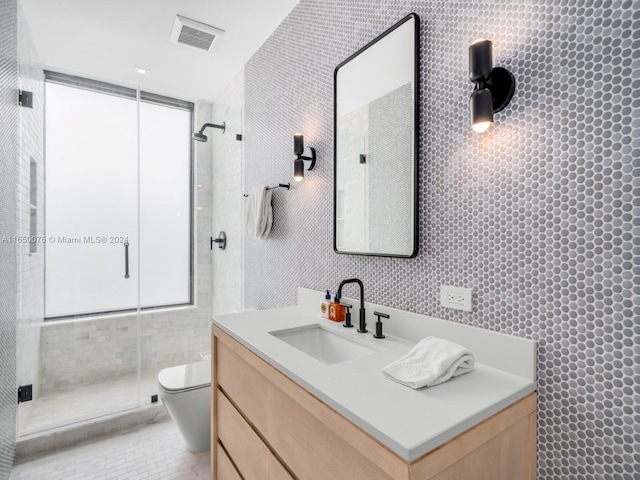 bathroom with a healthy amount of sunlight, a shower with shower door, toilet, and vanity