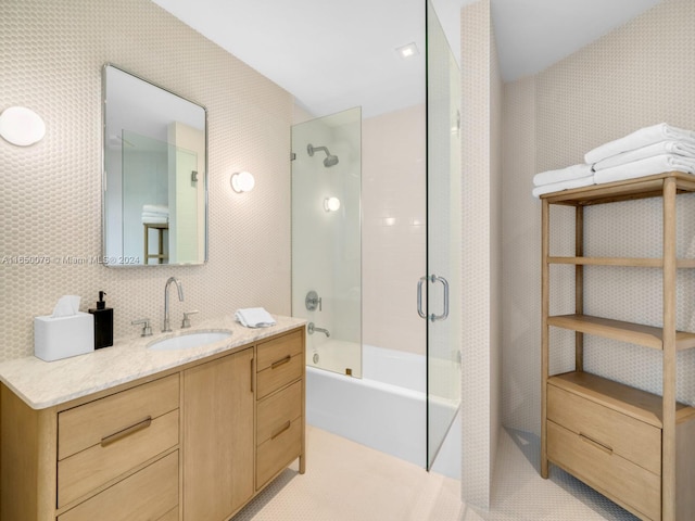 bathroom featuring vanity and combined bath / shower with glass door