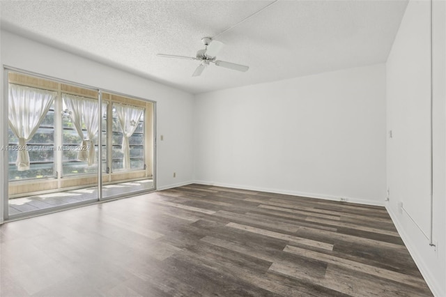 empty room featuring a textured ceiling, dark wood-type flooring, and ceiling fan