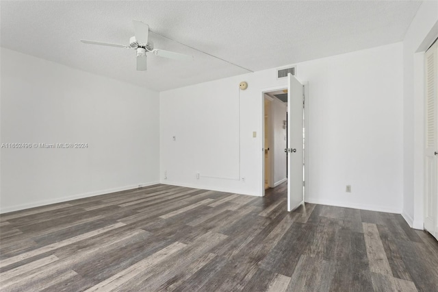 unfurnished room featuring ceiling fan, a textured ceiling, and dark wood-type flooring