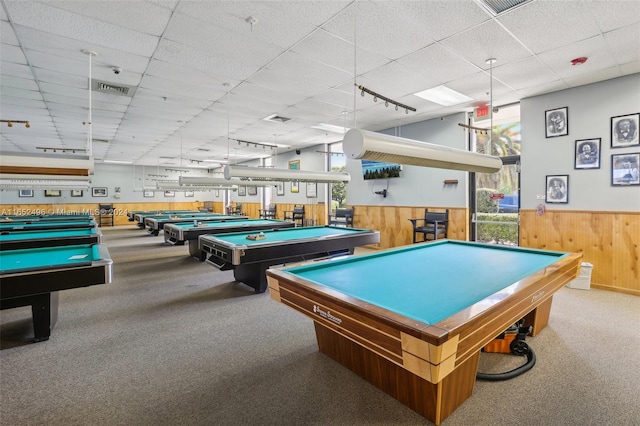 recreation room with light carpet, billiards, a paneled ceiling, and wood walls