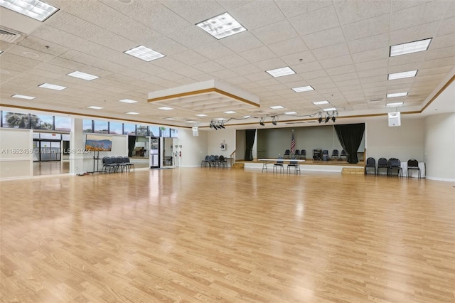 workout area with light hardwood / wood-style floors