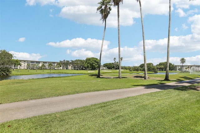 view of home's community featuring a water view and a yard