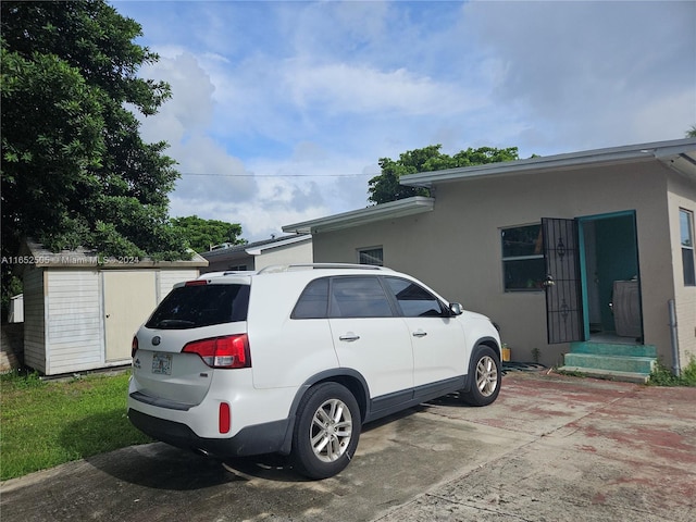 view of property exterior featuring a storage unit