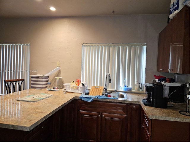 kitchen featuring dark brown cabinets, sink, and kitchen peninsula