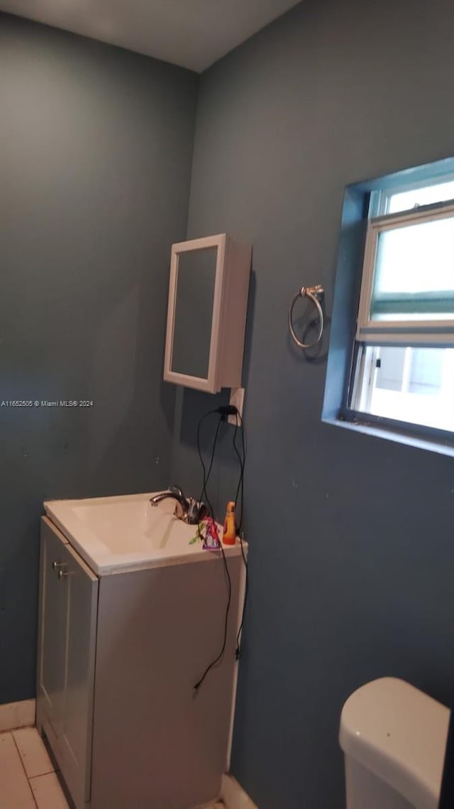 bathroom featuring tile patterned flooring, vanity, and toilet