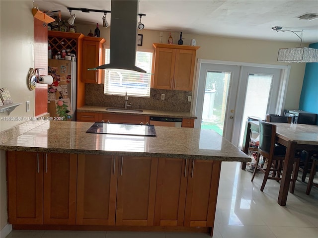 kitchen featuring island exhaust hood, decorative backsplash, french doors, stainless steel appliances, and sink