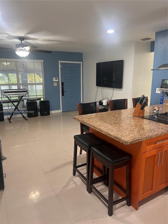 dining space featuring light tile patterned flooring and ceiling fan