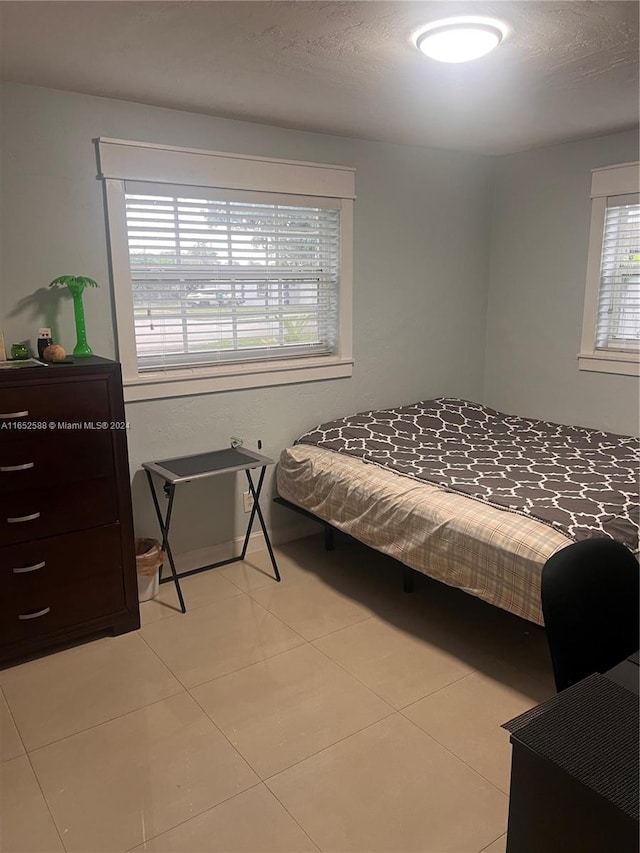 bedroom with light tile patterned flooring