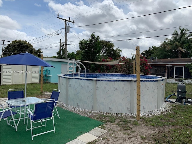 view of swimming pool with a storage unit and a patio