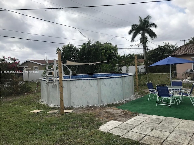 view of yard featuring a fenced in pool and a patio area