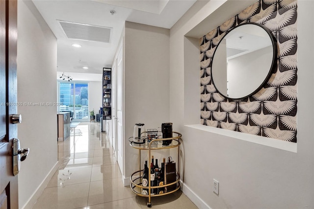 corridor featuring recessed lighting, light tile patterned flooring, visible vents, and baseboards