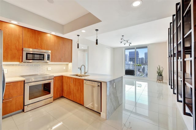 315 NE 3rd Ave Unit 1505, Fort Lauderdale, FL 33301 - kitchen with stainless steel appliances, decorative backsplash, brown cabinetry, light tile patterned floors, and recessed lighting