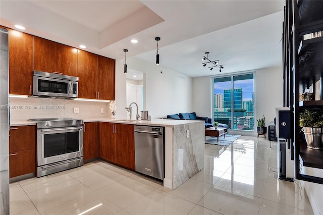 kitchen with a city view, tasteful backsplash, light countertops, appliances with stainless steel finishes, and open floor plan