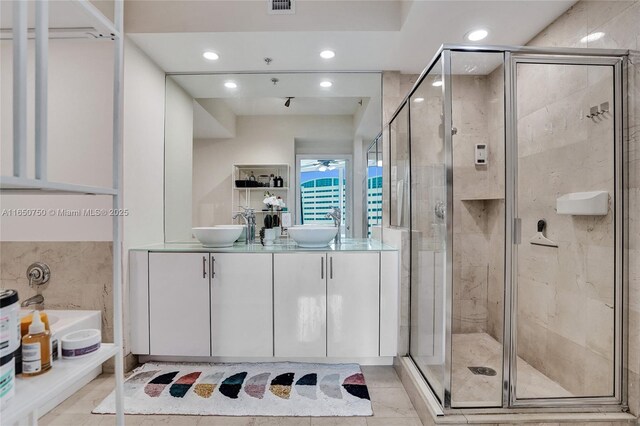 bathroom with double vanity, recessed lighting, a sink, and a shower stall