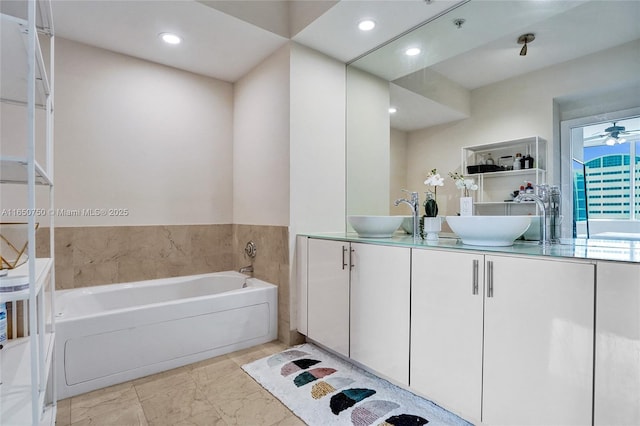 bathroom with double vanity, a sink, and recessed lighting