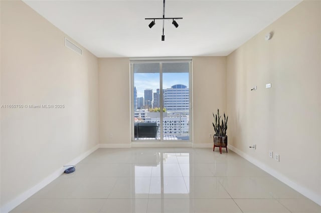 315 NE 3rd Ave Unit 1505, Fort Lauderdale, FL 33301 - spare room with tile patterned floors, a city view, and a smoke detector