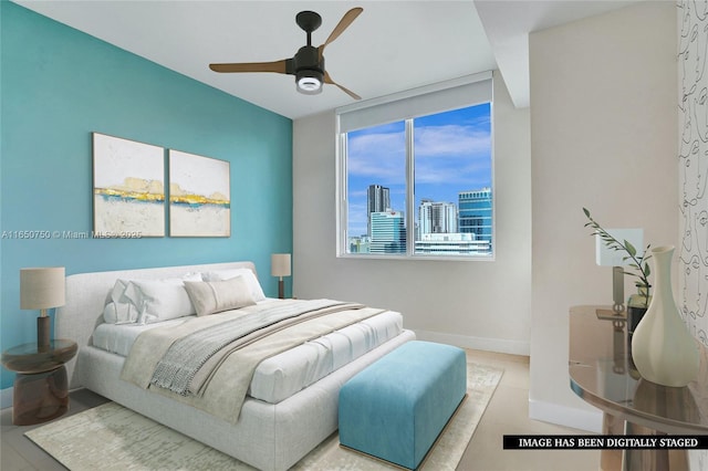 bedroom featuring baseboards, a ceiling fan, and a city view