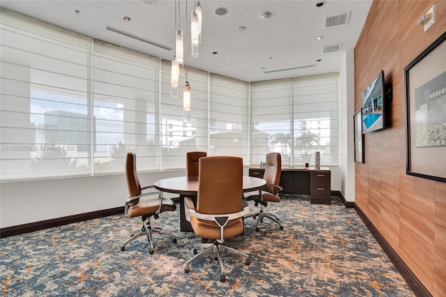 carpeted office space featuring baseboards and visible vents