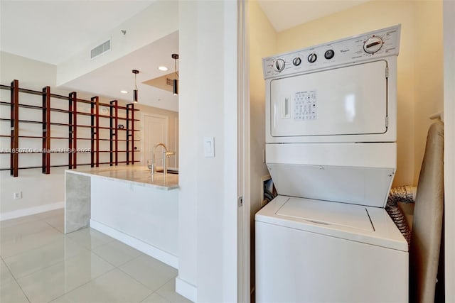 315 NE 3rd Ave Unit 1505, Fort Lauderdale, FL 33301 - washroom with stacked washing machine and dryer, light tile patterned floors, and recessed lighting