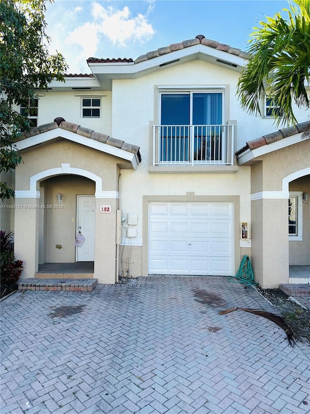 view of front of property with a garage and a balcony