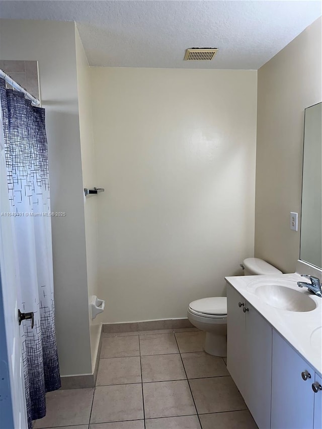 bathroom with tile patterned floors, toilet, a textured ceiling, vanity, and a shower with shower curtain