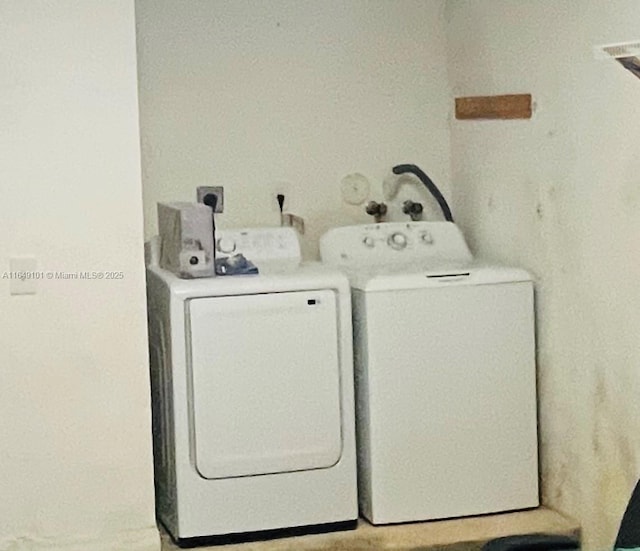 clothes washing area with washing machine and clothes dryer