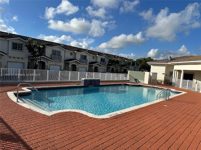 view of swimming pool with central AC unit and a patio area