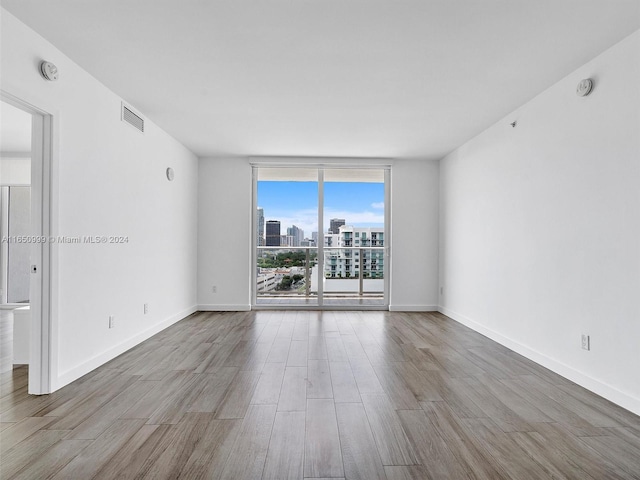 spare room with hardwood / wood-style flooring