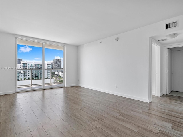 unfurnished room with light hardwood / wood-style floors