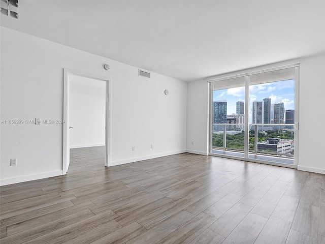 unfurnished room featuring hardwood / wood-style flooring