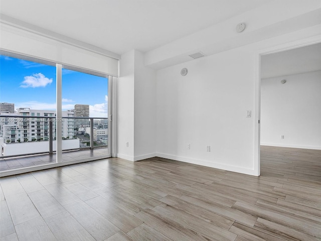 unfurnished room with light hardwood / wood-style flooring