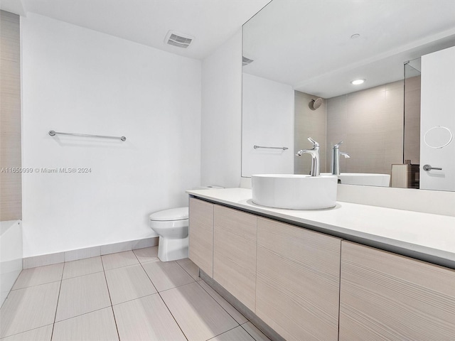 full bathroom with tile patterned floors, separate shower and tub, vanity, and toilet