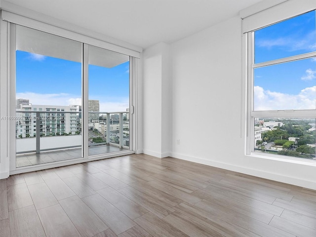 spare room with light hardwood / wood-style floors