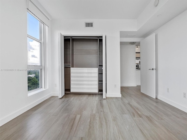 unfurnished bedroom featuring light wood-type flooring