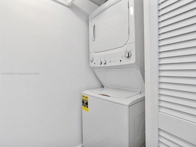 laundry area featuring stacked washer / dryer