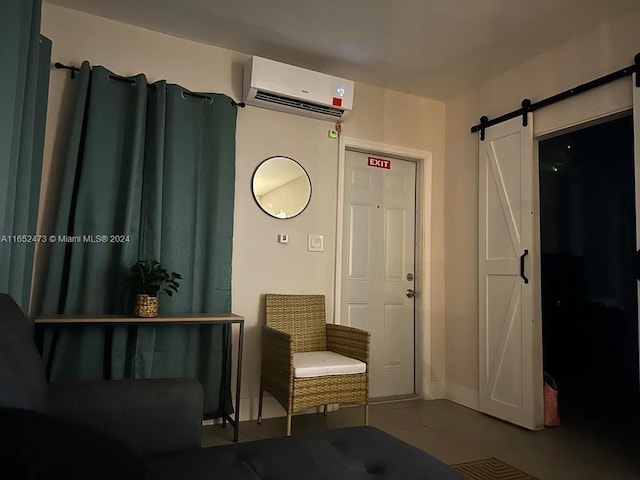 interior space with a barn door and a wall mounted air conditioner