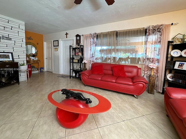 tiled living room featuring a textured ceiling and ceiling fan